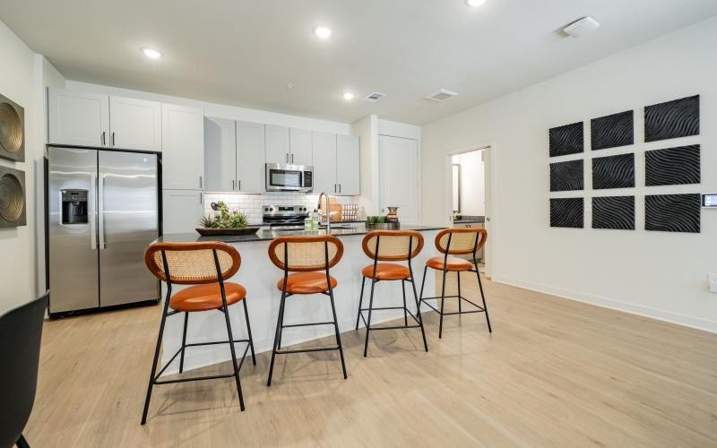 a kitchen with an island and chairs